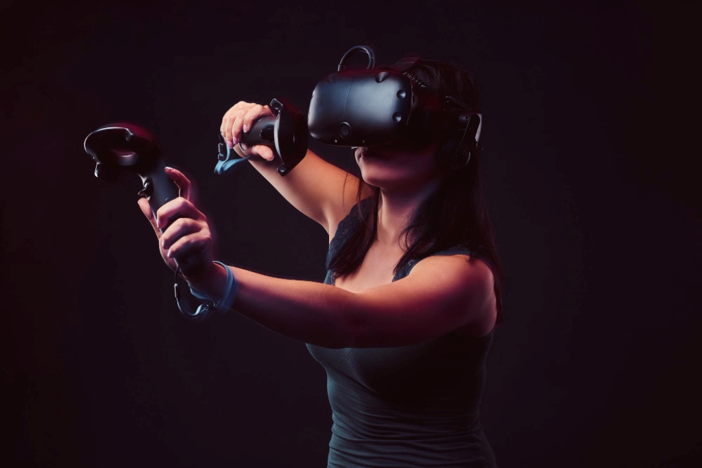 woman-with-virtual-reality-headset-joysticks-playing-video-games