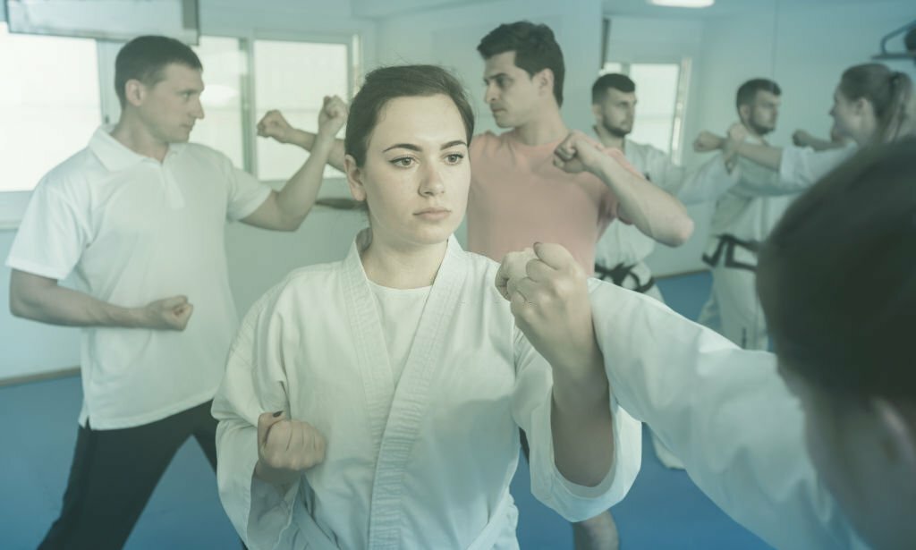 Portrait of a young girl in a taekwondo training in a gym